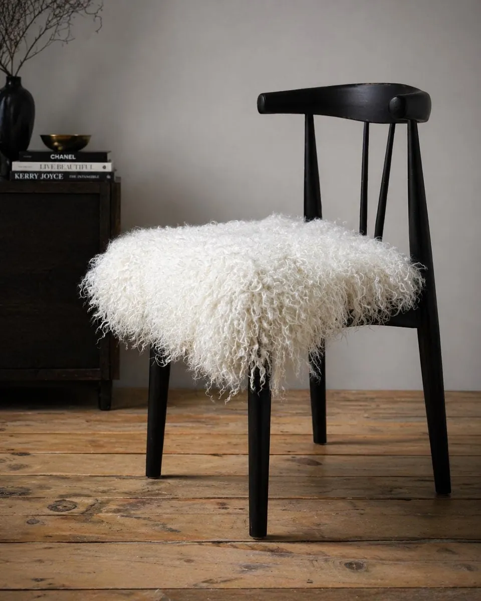 Curly Mongolian fur pad on a black dining chair